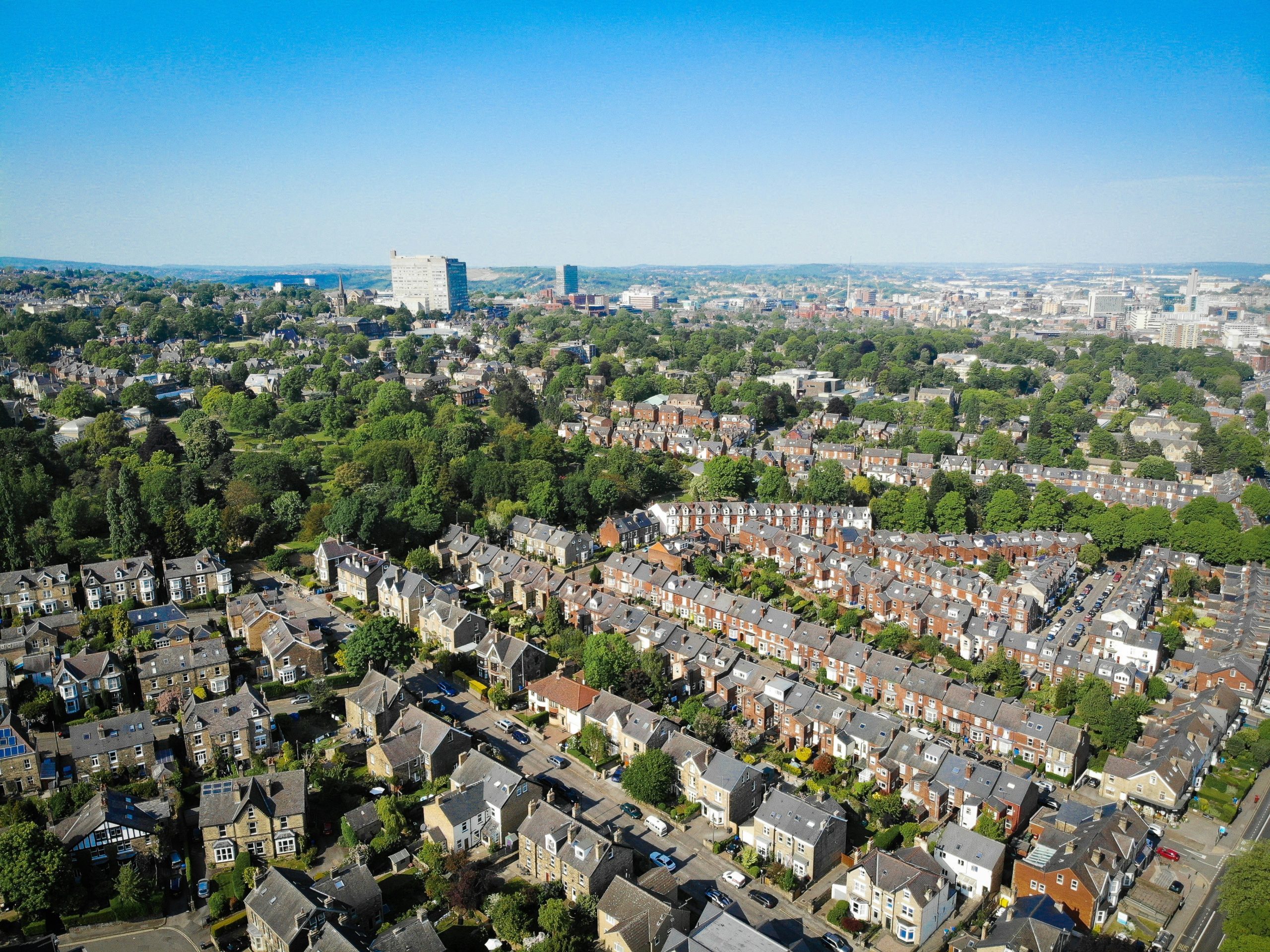 An aerial view of a UK city showing street after street of terraced housing